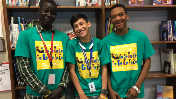 Close-up of 3 library helpers in their shirts